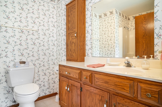 bathroom featuring tile patterned floors, vanity, and toilet