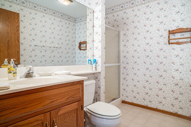 bathroom with vanity, toilet, and an enclosed shower