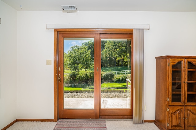 entryway featuring light colored carpet