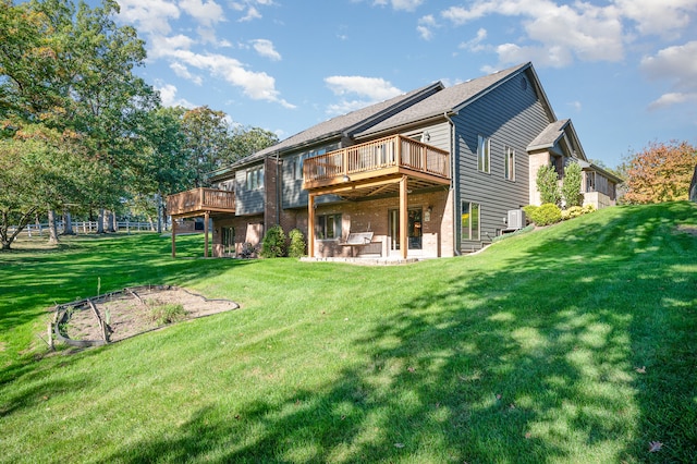 back of property with a lawn and a patio area