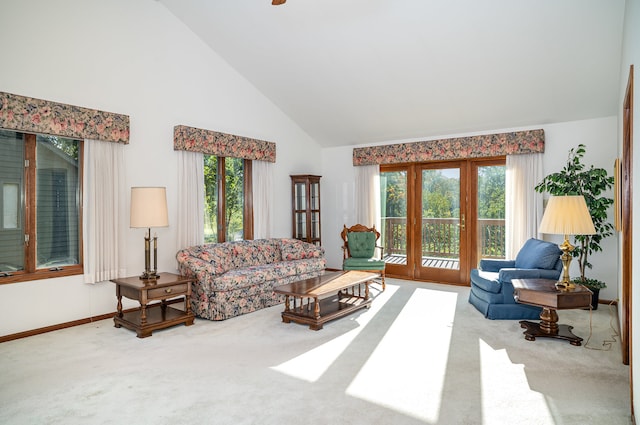 carpeted living room featuring high vaulted ceiling