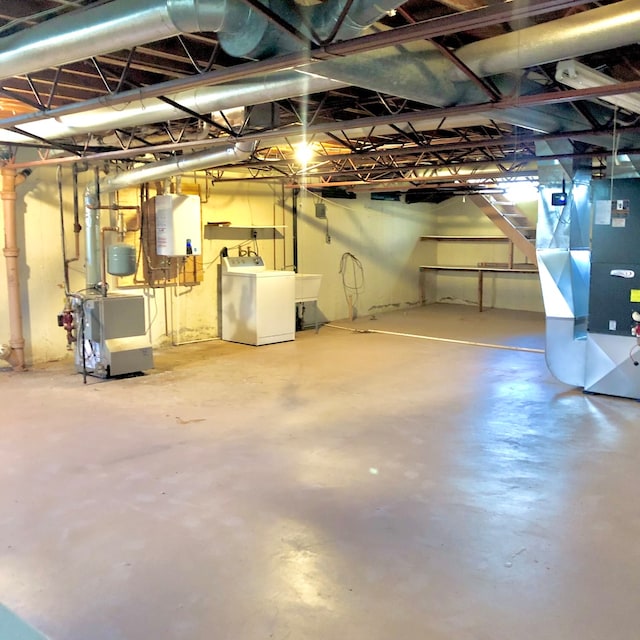 basement with washer / dryer, heating unit, and tankless water heater