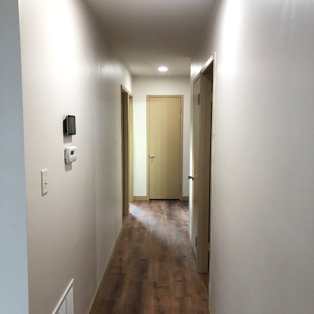 hallway featuring dark hardwood / wood-style flooring