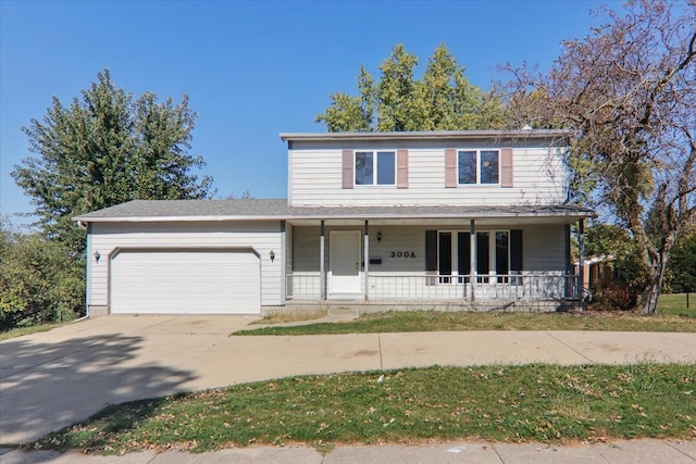 view of property featuring a garage and covered porch