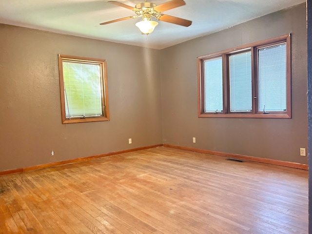 spare room with light hardwood / wood-style flooring and ceiling fan