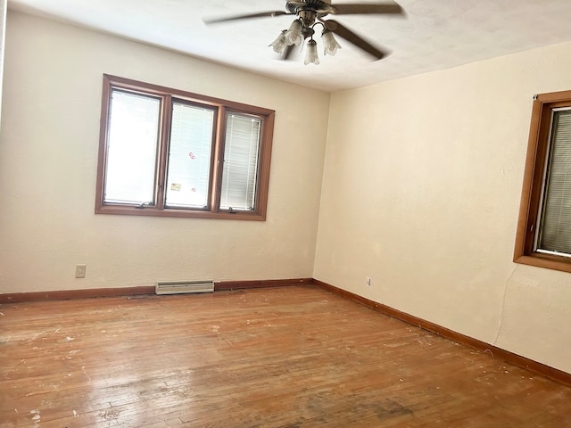 spare room featuring ceiling fan and hardwood / wood-style flooring