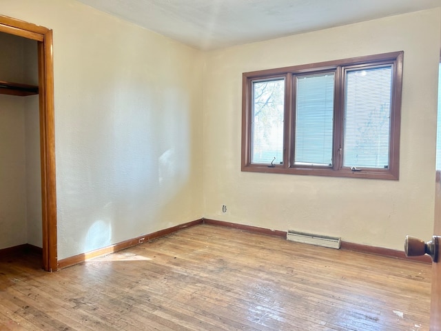 unfurnished bedroom featuring a closet and light hardwood / wood-style floors