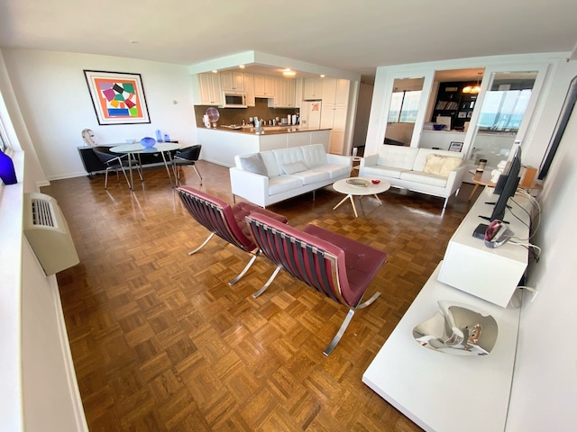 living room featuring dark parquet floors