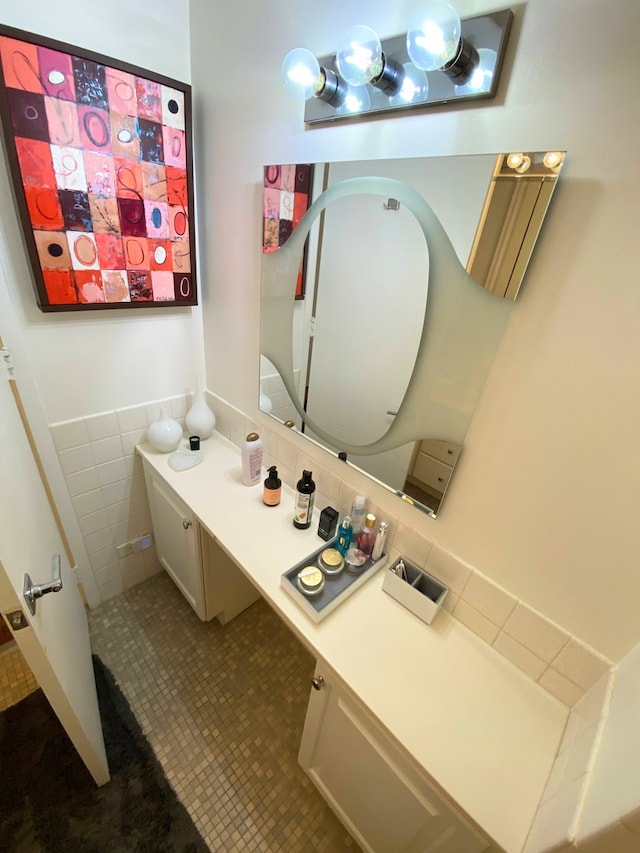 bathroom featuring tile patterned flooring, vanity, and tile walls