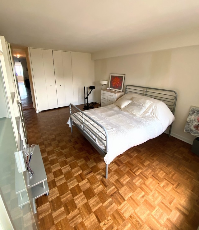 bedroom with dark parquet flooring