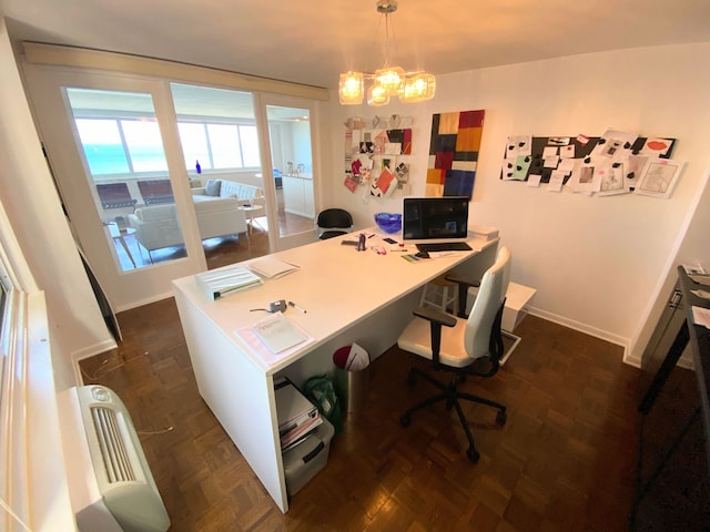 office space with a notable chandelier and dark parquet floors