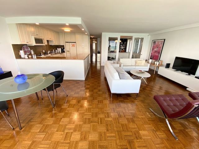 living room featuring dark parquet floors