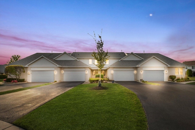 view of front of home featuring a lawn and a garage