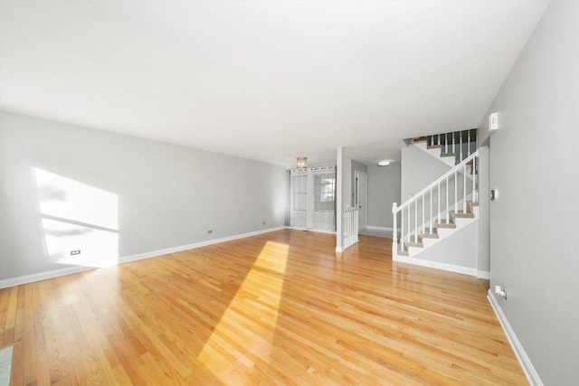 unfurnished living room with hardwood / wood-style flooring