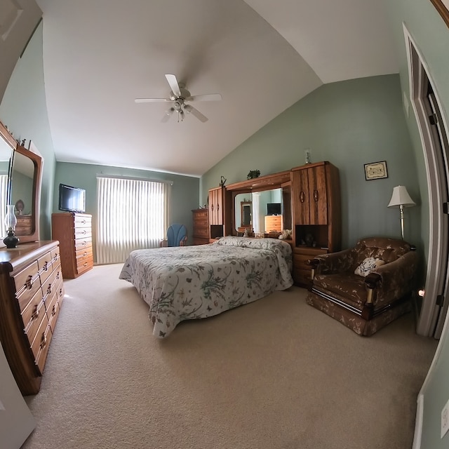 carpeted bedroom with ceiling fan and vaulted ceiling