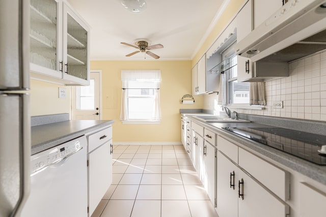 kitchen featuring decorative backsplash, white cabinets, crown molding, white dishwasher, and light tile patterned floors