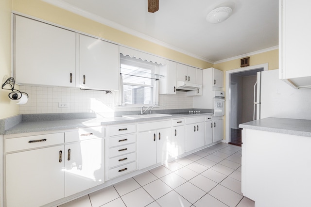 kitchen featuring sink, white cabinetry, ornamental molding, white oven, and backsplash