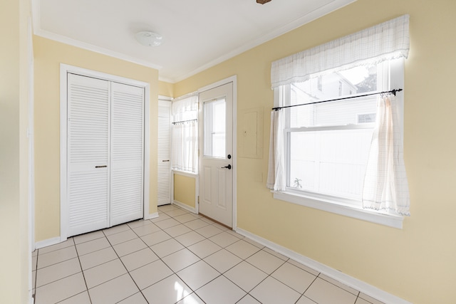 entrance foyer with light tile patterned floors and ornamental molding