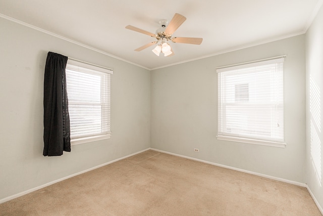 carpeted empty room featuring crown molding and ceiling fan