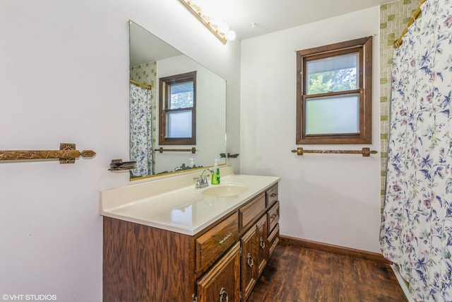 bathroom featuring vanity, hardwood / wood-style floors, and a wealth of natural light