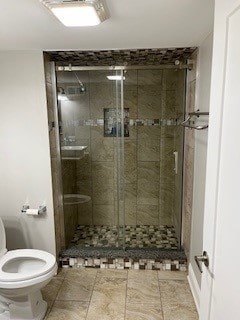 bathroom featuring walk in shower and toilet