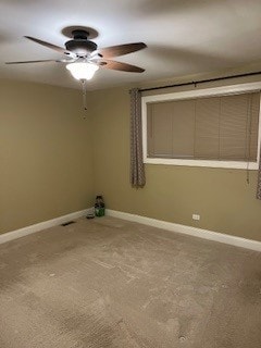 carpeted spare room with ceiling fan