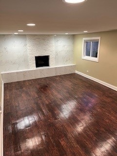 unfurnished living room with a fireplace and dark hardwood / wood-style flooring