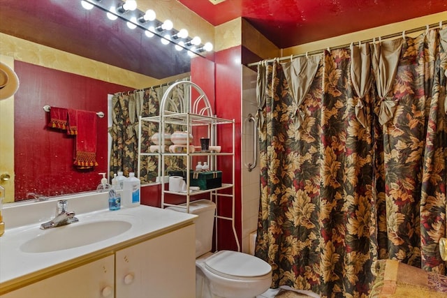 bathroom featuring walk in shower, vanity, and toilet