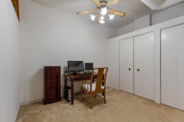 carpeted office with ceiling fan