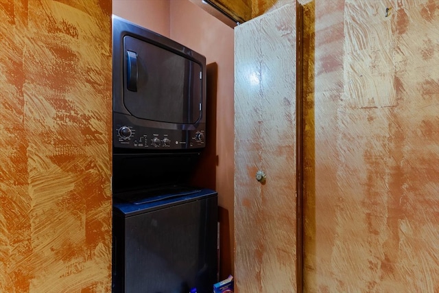 washroom with stacked washer / drying machine