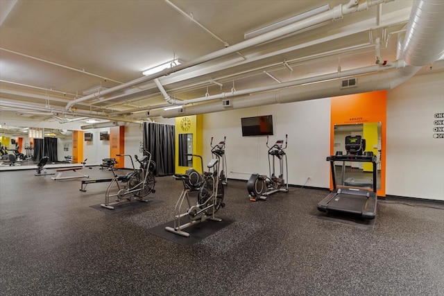 exercise room featuring a baseboard heating unit