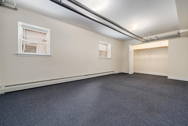 garage with a baseboard heating unit and baseboards