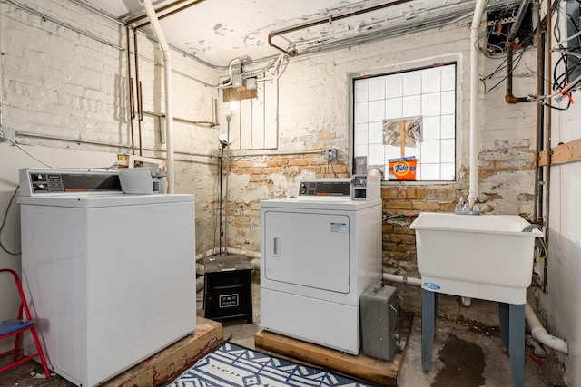 washroom featuring washer and clothes dryer and sink