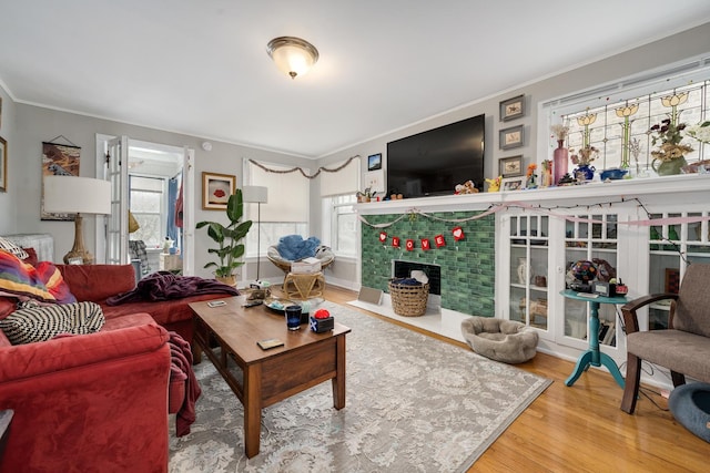 living room with hardwood / wood-style flooring and crown molding