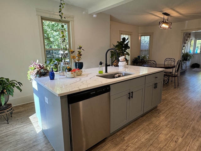 kitchen with a center island with sink, pendant lighting, plenty of natural light, and dishwasher