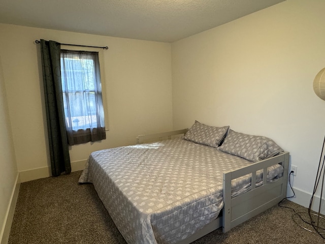 bedroom featuring carpet floors and a textured ceiling