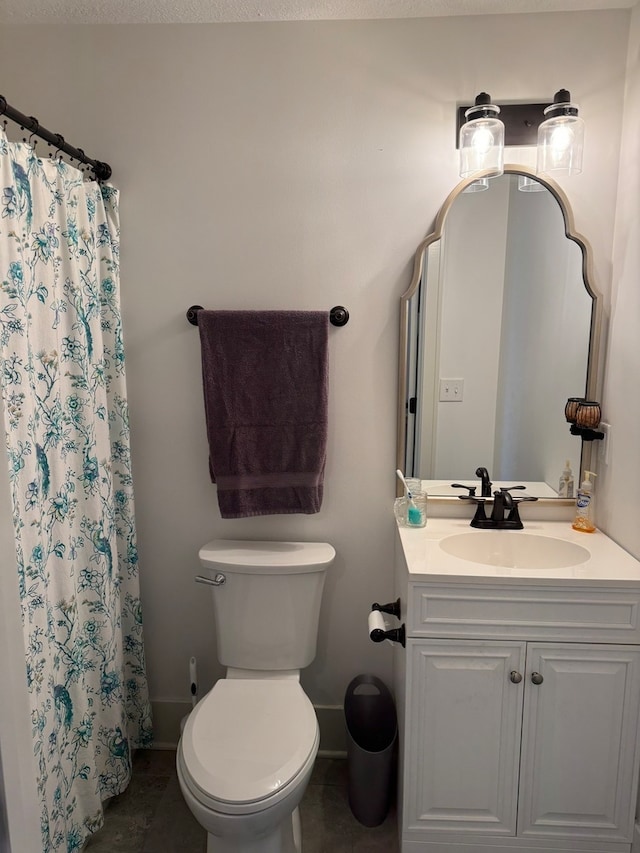 bathroom featuring tile patterned floors, vanity, toilet, and curtained shower