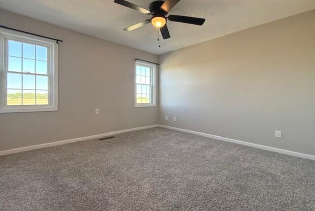 2501 Woodridge Pl, Champaign, IL 61822 - unfurnished room with baseboards, ceiling fan, and carpet