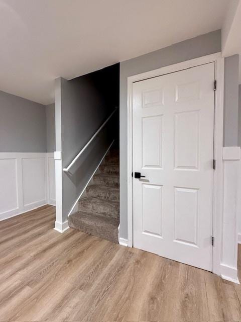 2501 Woodridge Pl, Champaign, IL 61822 - stairway featuring wood finished floors, wainscoting, and a decorative wall