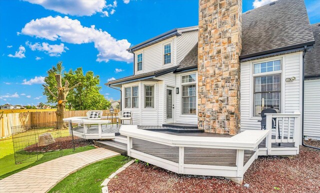 2501 Woodridge Pl, Champaign, IL 61822 - back of property with a wooden deck, a chimney, and a shingled roof