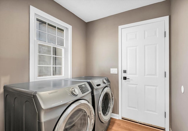 2501 Woodridge Pl, Champaign, IL 61822 - laundry area with separate washer and dryer, light wood-style floors, and baseboards
