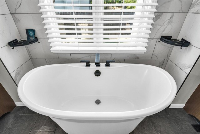 2501 Woodridge Pl, Champaign, IL 61822 - full bathroom featuring a freestanding tub, tile patterned floors, and tile walls