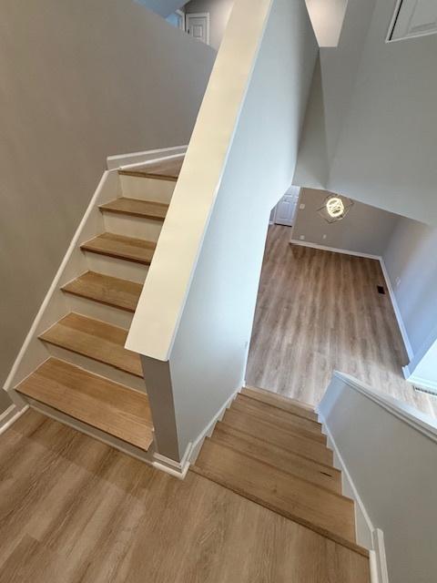 2501 Woodridge Pl, Champaign, IL 61822 - stairway with wood finished floors and baseboards