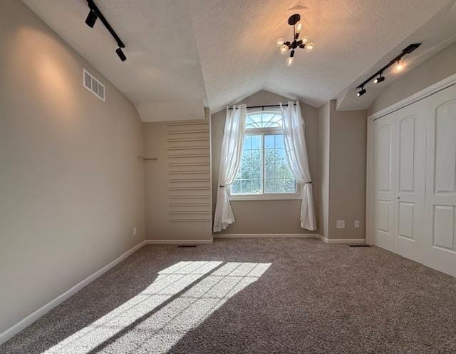 2501 Woodridge Pl, Champaign, IL 61822 - bonus room featuring vaulted ceiling, a textured ceiling, carpet floors, baseboards, and a chandelier