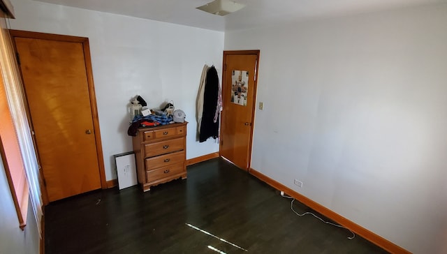 bedroom with dark wood-type flooring