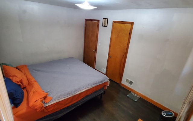 bedroom featuring dark hardwood / wood-style flooring