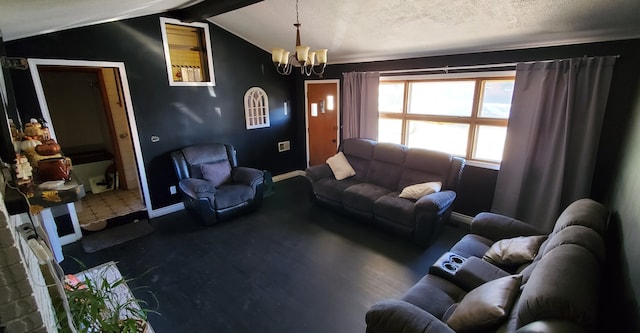 living room with a notable chandelier, vaulted ceiling with beams, and a textured ceiling