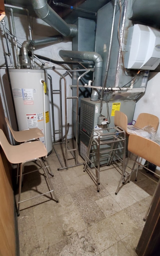 utility room featuring water heater