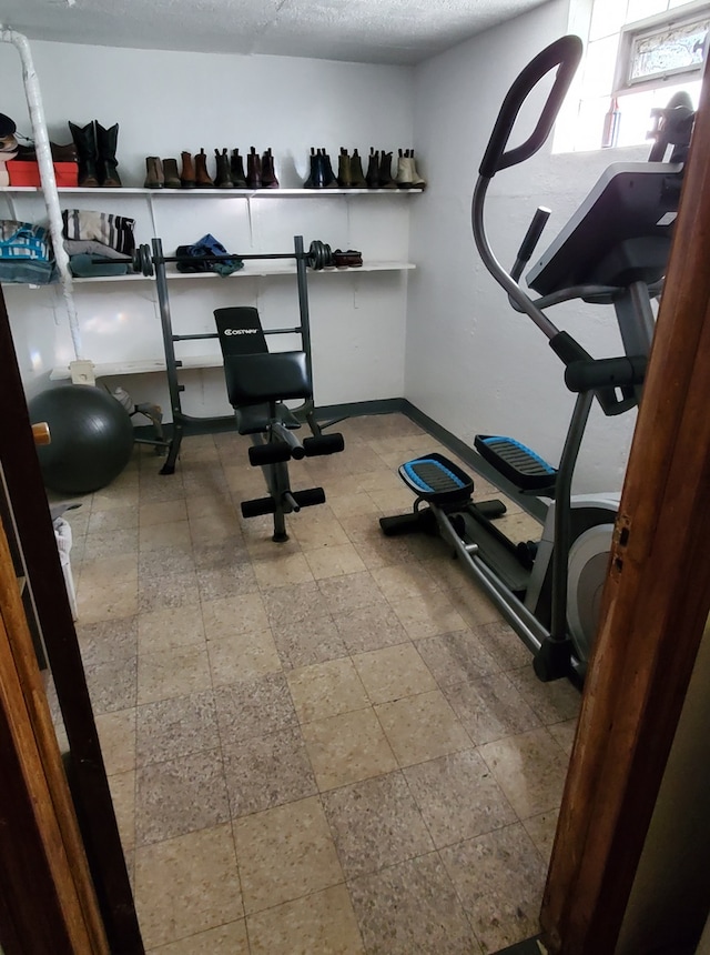 exercise room with a textured ceiling