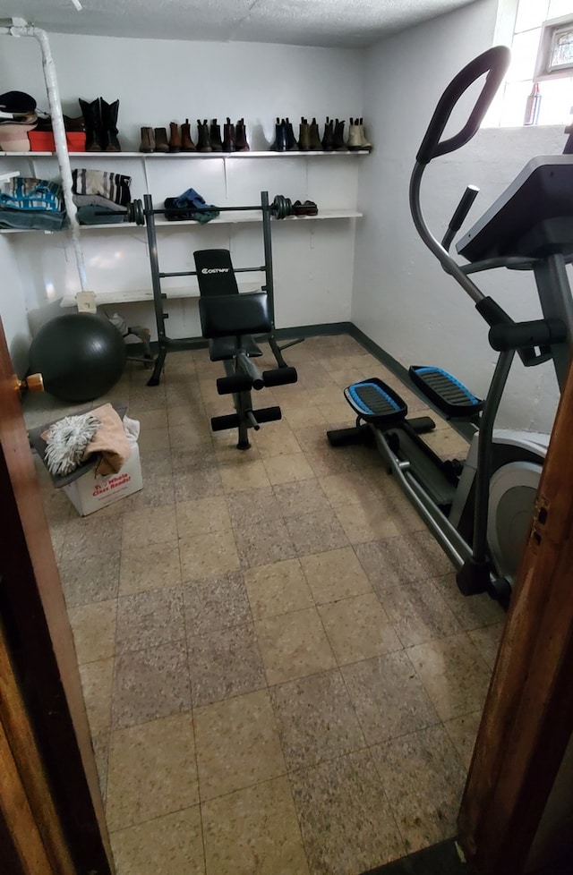 exercise room with a textured ceiling